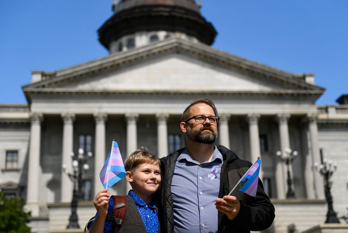 Dylan Dittrich-Reed and his son, Niko, pose for a portrait outside of the S.C. Statehouse on Wednesday, March 29, 2023. Dittrich-Reed is worried he will have to move his family out of state if they cannot get gender-affirming health care for his son.