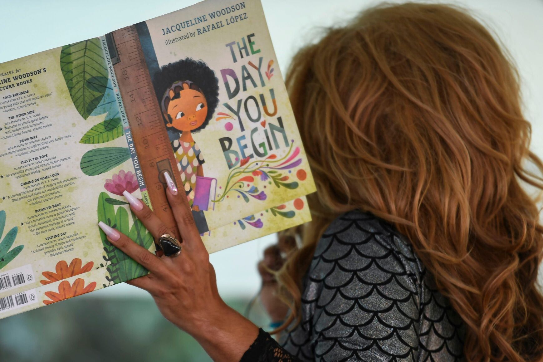 Princess Mocha reads a book during drag queen story hour at the annual Upstate Pride Festival in downtown Spartanburg on Saturday, Oct. 28, 2023.