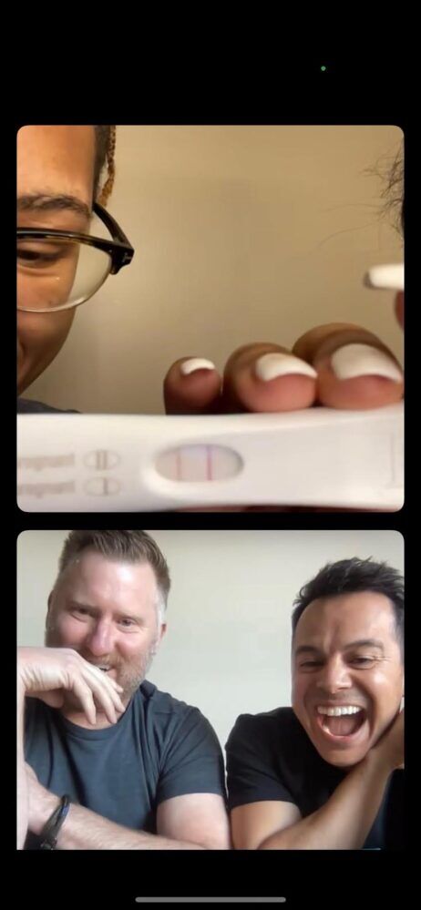 Hilliard holds up a positive pregnanct test on facetime as the couple looks extremely overjoyed