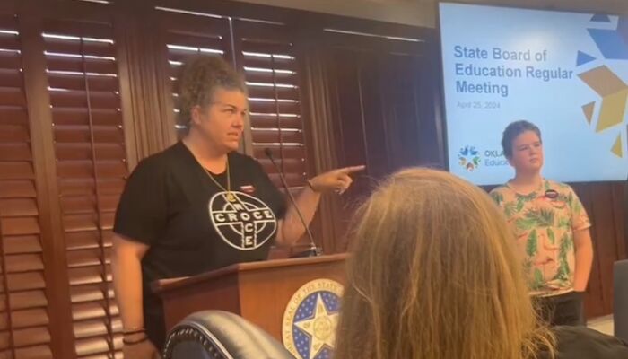 Parent arrested at state meeting after calling GOP education head a “bigot & a bully”