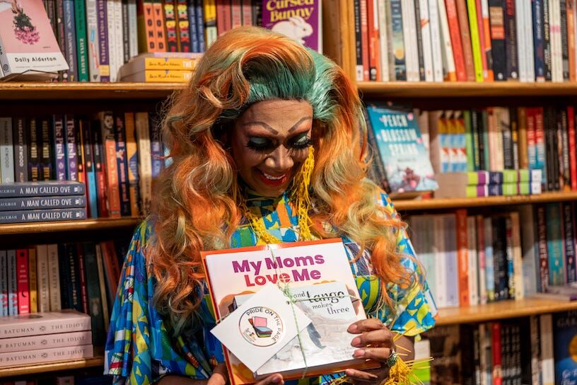 Harmonica Sunbeam looks a bundle of inclusive pre-K books during a launch party for Pride on the Page at Watchung Booksellers in Montclair, NJ on Thursday March 2, 2023. The event, thrown by Out Montclair Families, is to ensure LGBTQIA+ inclusive books are in schools, libraries and daycares. Pride On The Page