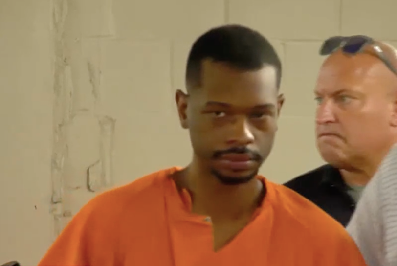 Marcus Johnson is a 33-year-old Black man wearing an orange jumpsuit in this jail footage