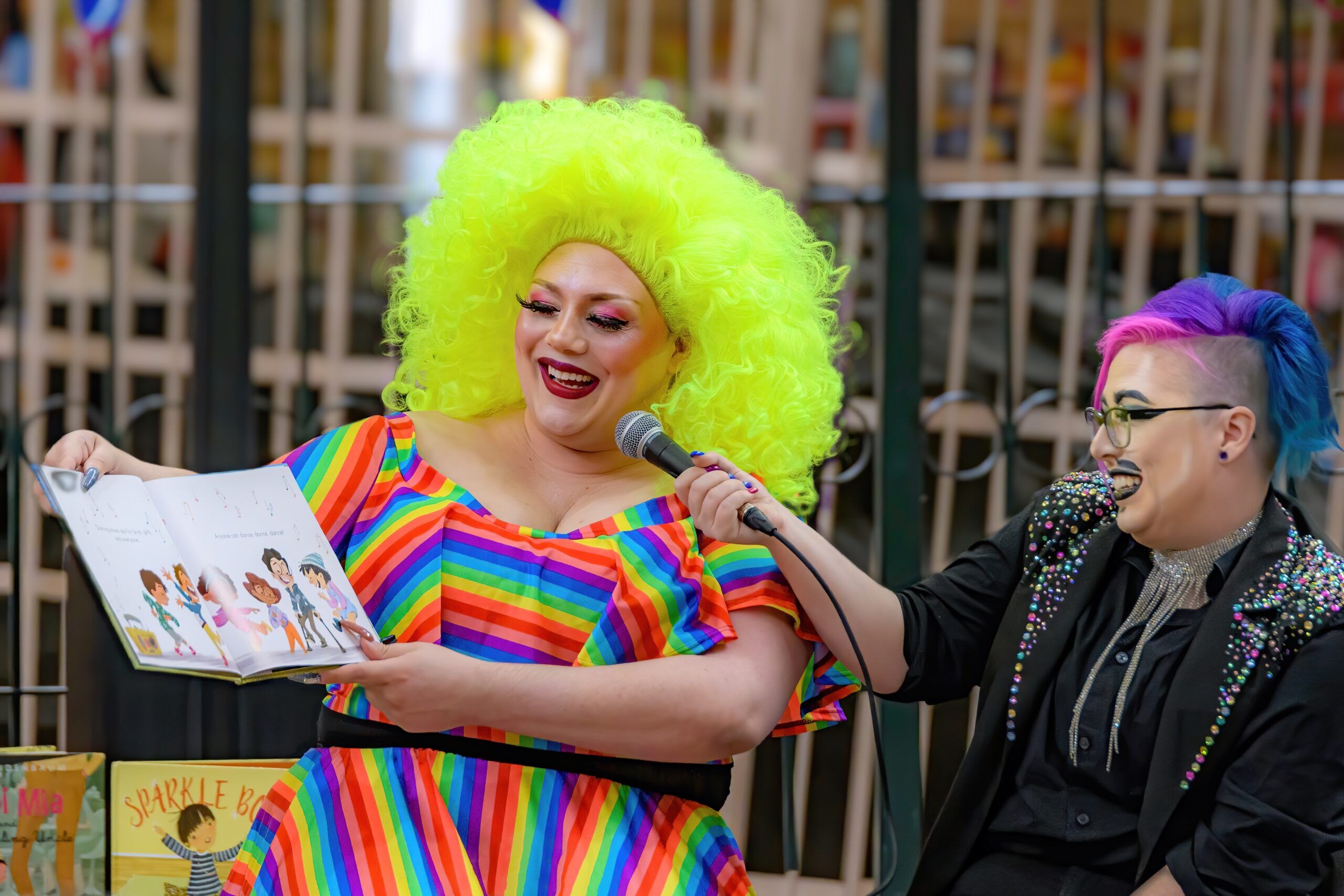 Saint John, NB, Canada - June 5, 2022: A drag queen and king read children's stories at the Drag Story Hour in Market Square. Focus on the queen.