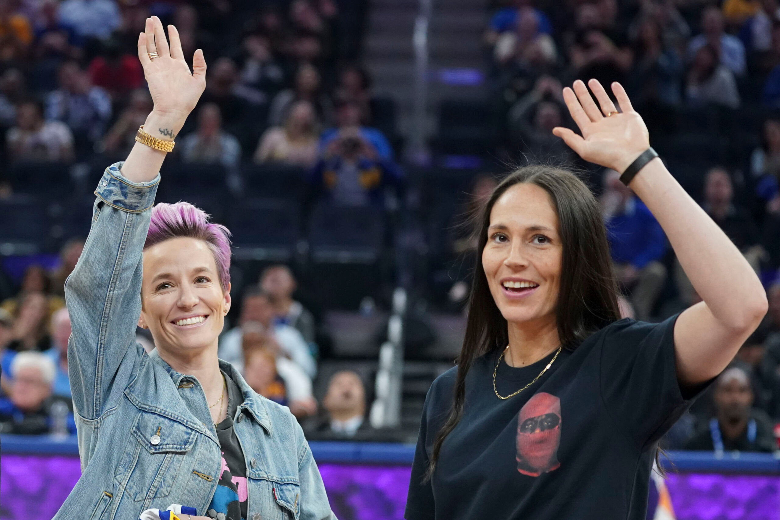 October 30, 2019; San Francisco, CA, USA; Megan Rapinoe (left) and Sue Bird (right) wave during the second quarter between the Golden State Warriors and the Phoenix Suns at Chase Center. Mandatory Credit: Kyle Terada-USA TODAY Sports