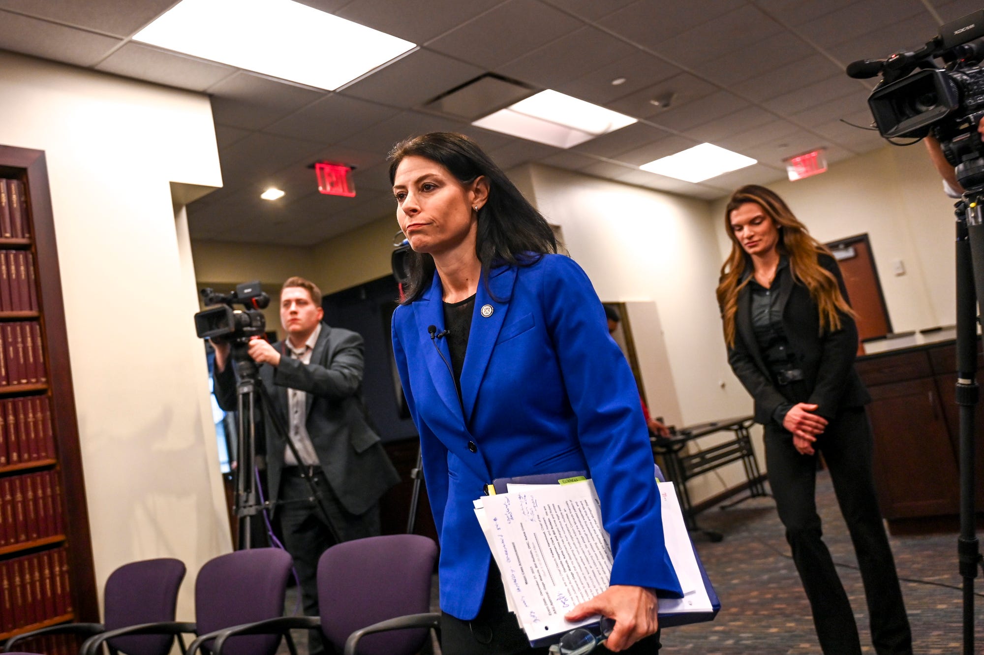 makes her way to the podium before announing charges in a public integrity investigation during a press conference on Thursday, Dec. 21, 2023, at the G. Mennen Williams Building in downtown Lansing.