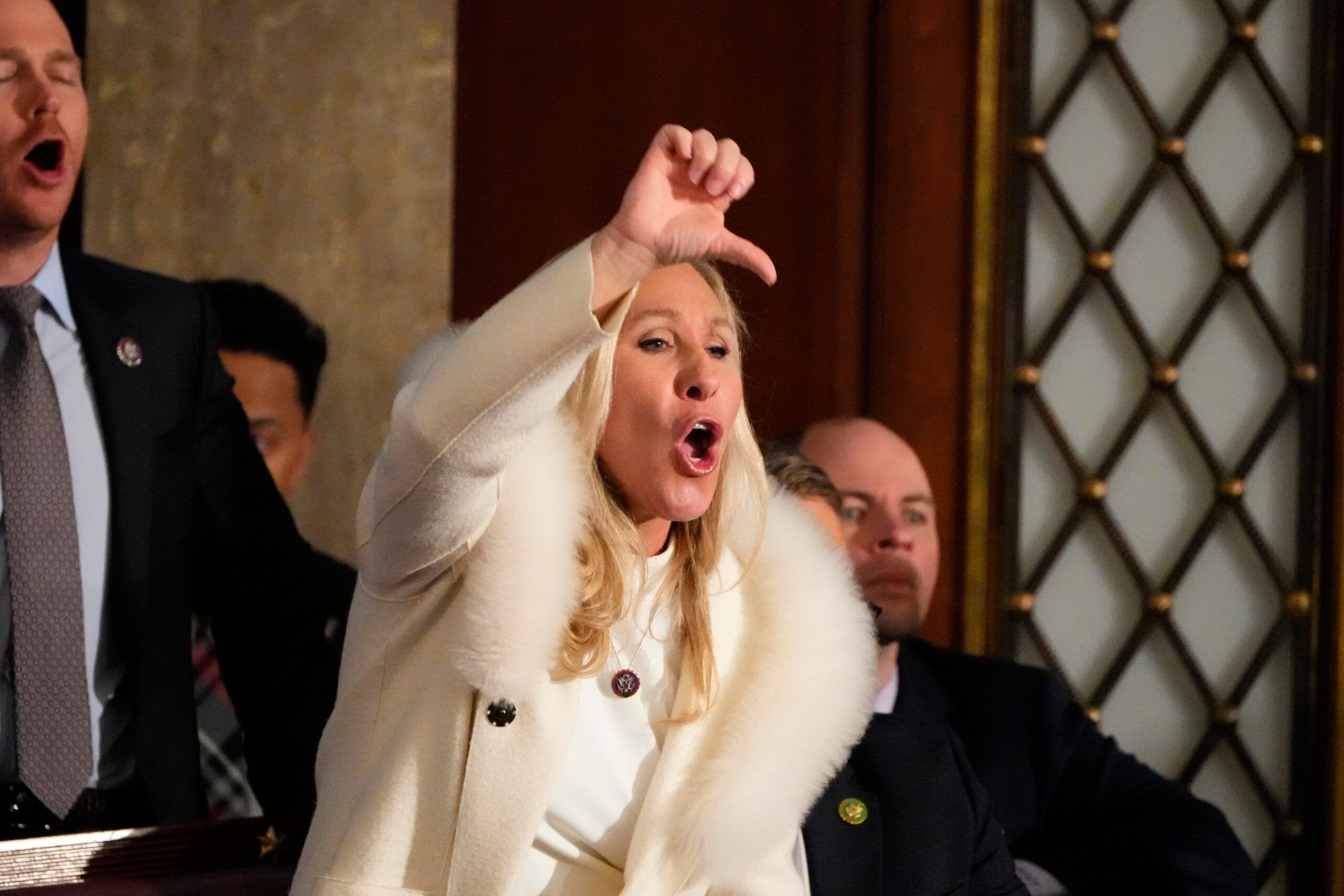 Rep. Marjorie Taylor Greene yells in the chambers as President Joe Biden speaks during the 2023 State of the Union address