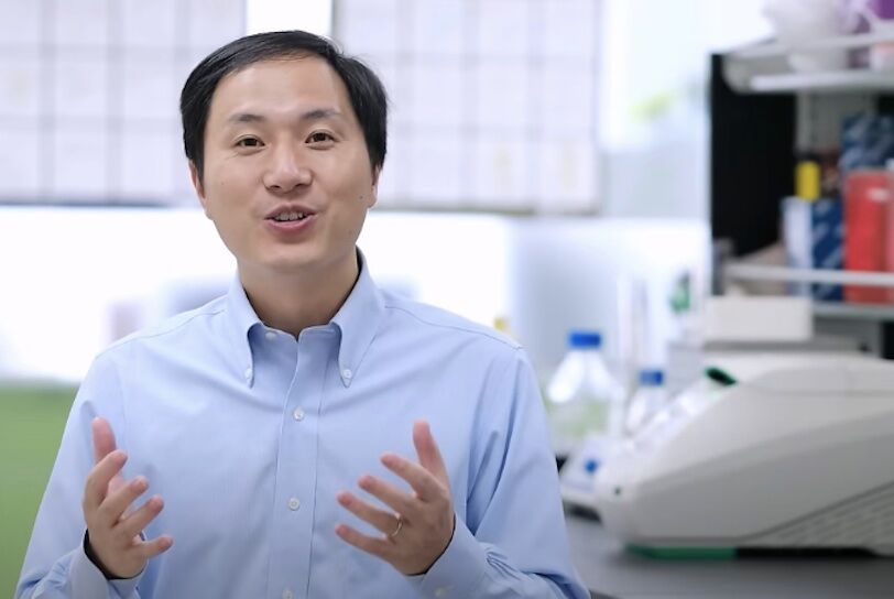 He Jiankui is a Chinese genetic scientist. In this image, he faces the camera in a brighly lit science lab.