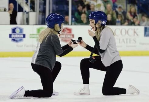 Fans stand & cheer as two women propose during pro-ice hockey game