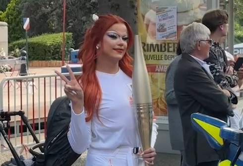 Drag star Nicky Doll carries the Olympic flame