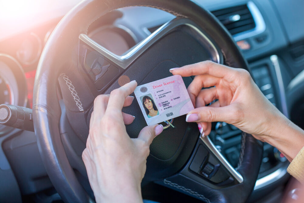 A person in a car with a drivers license