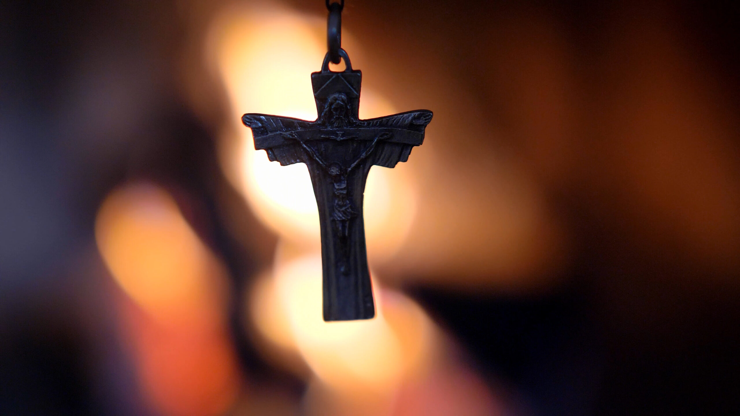 Crucifix Silhouette on Fire Flames Defocused Dark Background Slow Motion