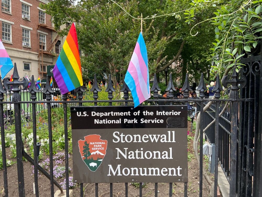 National Stonewall Monument with rainbow and trans pride flags