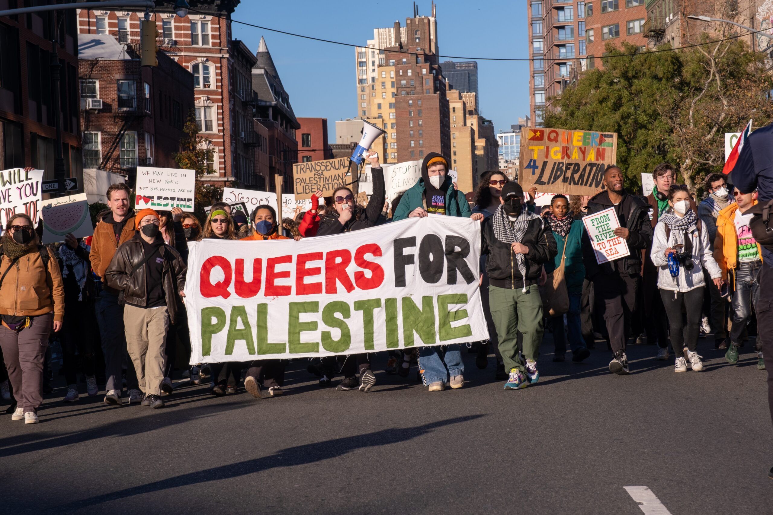 New York, NY, USA November 12, 2023: Queers for Palestine March from Union Square ending at Stonewall. Marchers on 7th avenue in the West Village carrying a Queers for Palestine banner.