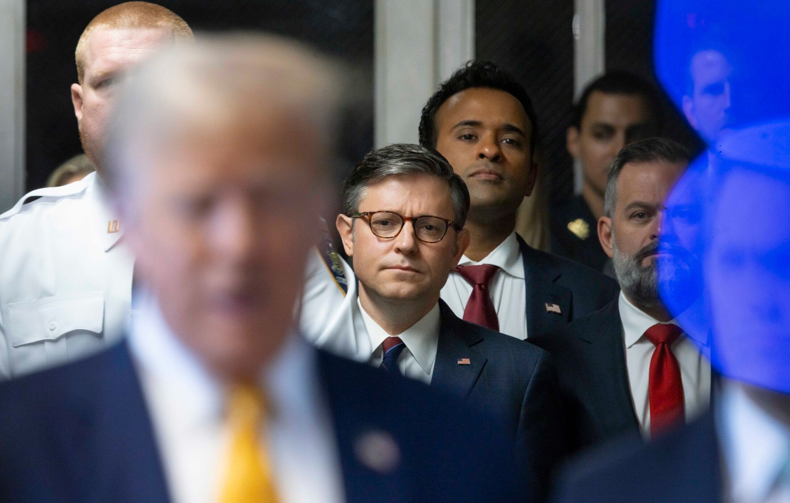 May 14, 2024; New York, NY, USA; Speaker of the House Mike Johnson (center), and Vivek Ramaswamy (right) look on while former President Donald Trump speaks to the media alongside his lawyer Todd Blanche before his criminal trial at Manhattan criminal court at the New York State Supreme Court on May 14, 2024. Mandatory Credit: Justin Lane/Pool via USA TODAY NETWORK