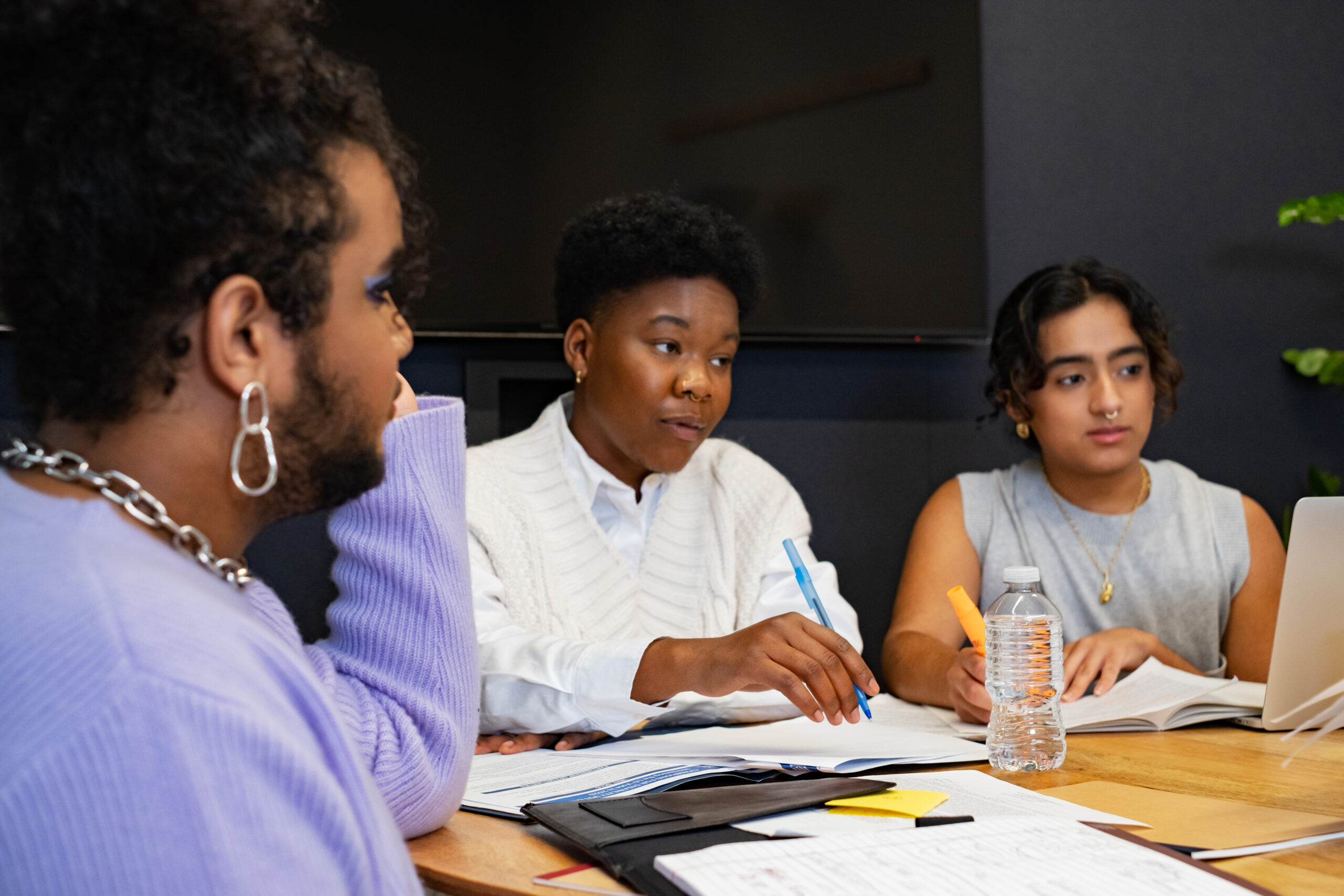A group of co-workers of varying genders having a meeting A group of co-workers of varying genders having a meeting