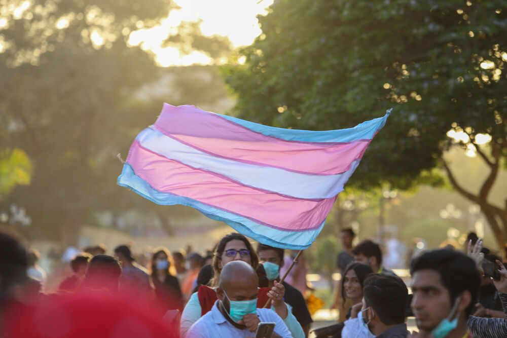 A trans Pride flag is flown at the International Women's Day March in Karachi, Pakistan on March 8, 2021