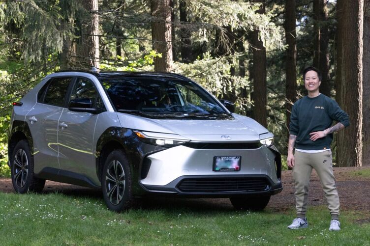 Sports Bra owner Jenny Nguyen stands before Toyota’s Bz4X all-electric powertrain.