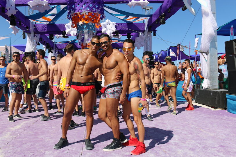 MIAMI BEACH, FLORIDA, MARCH 6, 2016: Winter Party Festival, Ocean Drive in Miami Beach, LGBTQ Gay Beach Party, Group of gay men in swimwear