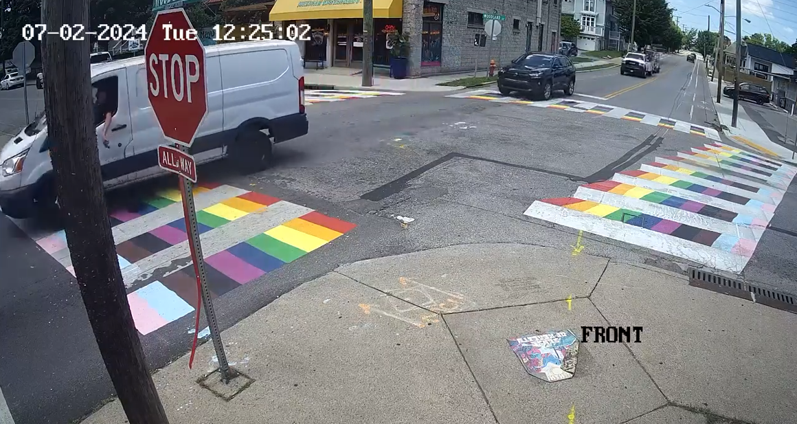 An image of surveillance footage showing a man vandalizing Nashville's rainbow crosswalk