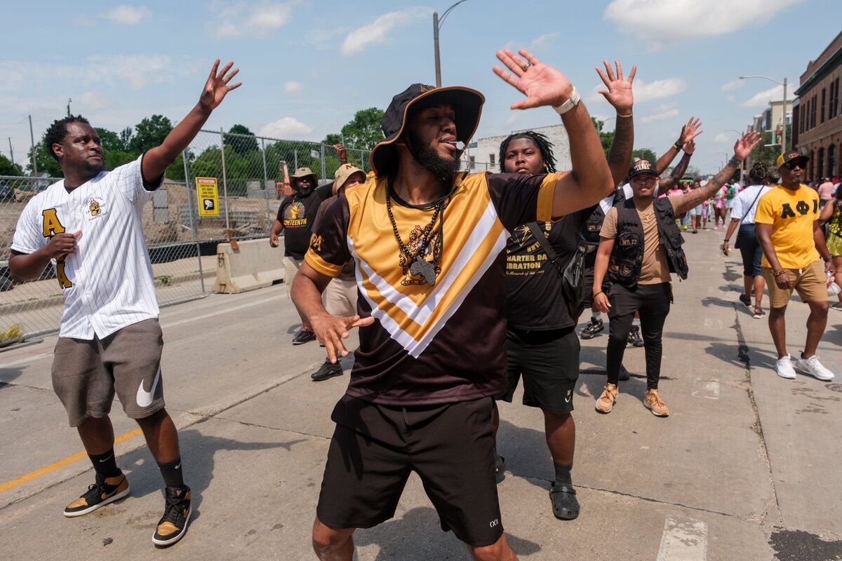 Members of the Alpha Phi Alpha Fraternity, Inc. step during the 2024 Juneteenth Parade in Milwaukee on Wednesday, June 19, 2024.