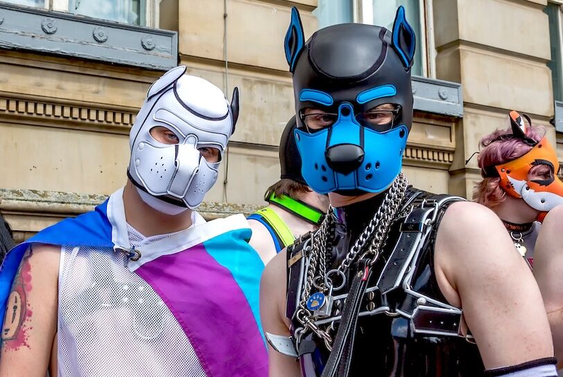 Birmingham, UK - May 25, 2019 - Pups wearing dog masks and costumes meet up before the Pride parade through Birmingham City centre.