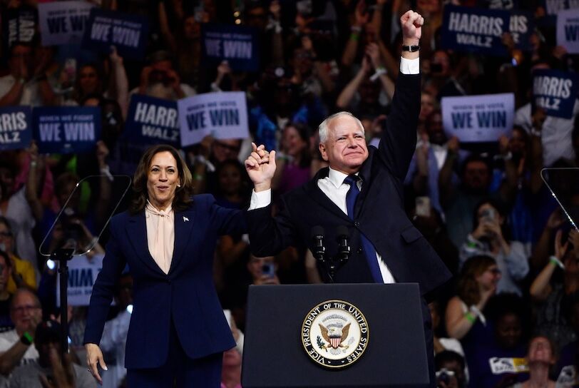 Vice President Kamala Harris holds hands with her running mate Minnesota Governor Tim Walz as Harris holds a rally at Temple University in Philadelphia on Tuesday, August 6, 2024.