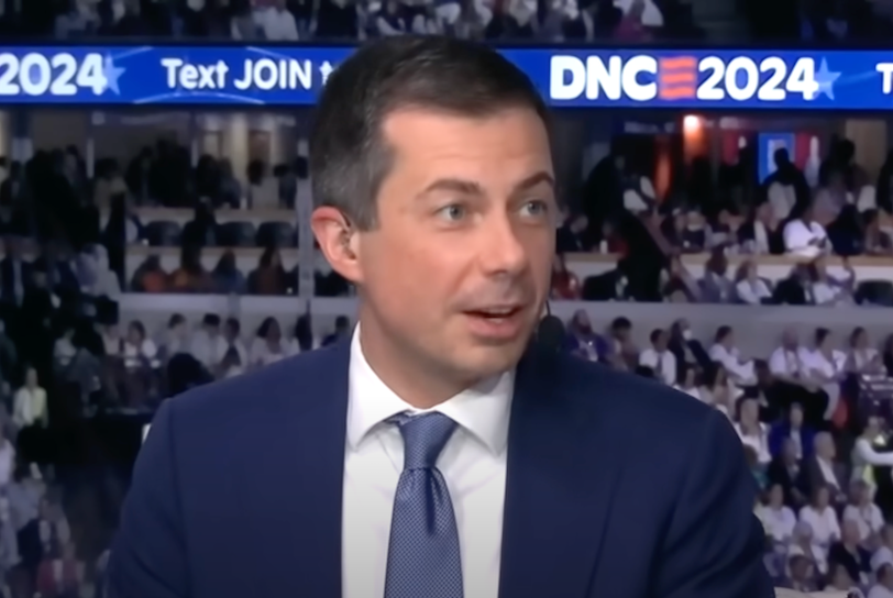 Pete Buttigieg is a 42-year-old clean cut white man with black hair in a blue blazer jacket and tie.