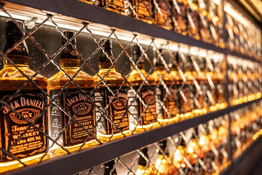 bottles of jack daniel's behind a wire grid