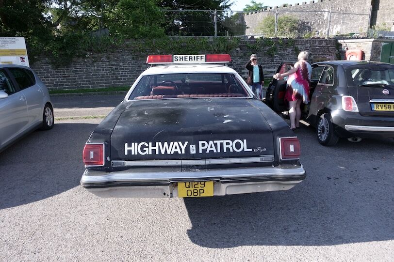 28th July 2024- A classic Oldsmobile Delta 88 Royale sedan, in Highway Patrol livery, parked in the public carpark at Laugharne, Carmathenshire, Wales, UK.