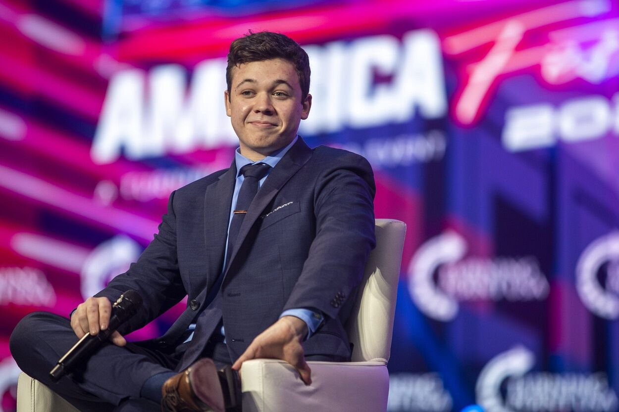 Kyle Rittenhouse listens to the crowd cheer for him before a panel discussion during the third day of AmericaFest 2021 hosted by Turning Point USA on Sunday, Dec. 19, 2021, in Phoenix.