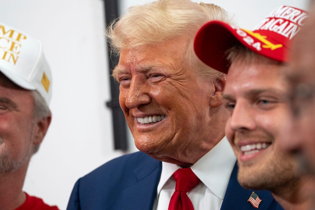 Former president Donald Trump poses for photos with supporters after speaking at the Trump Force 47 campaign office in Roseville on Monday, August 26, 2024.