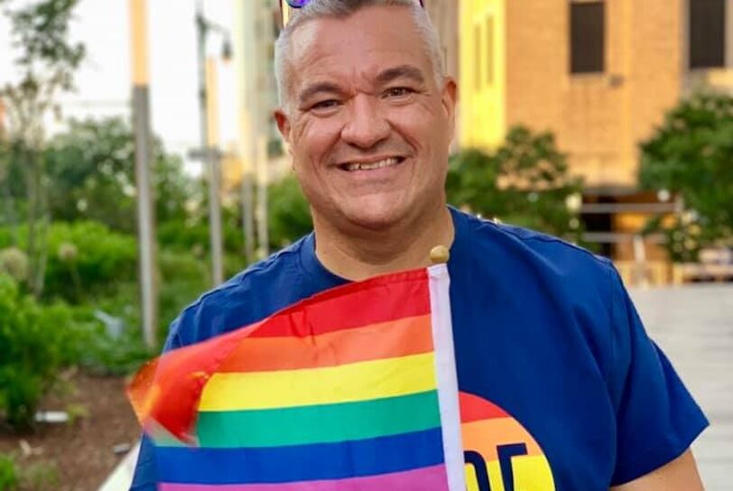 Christopher Cole with a Pride flag