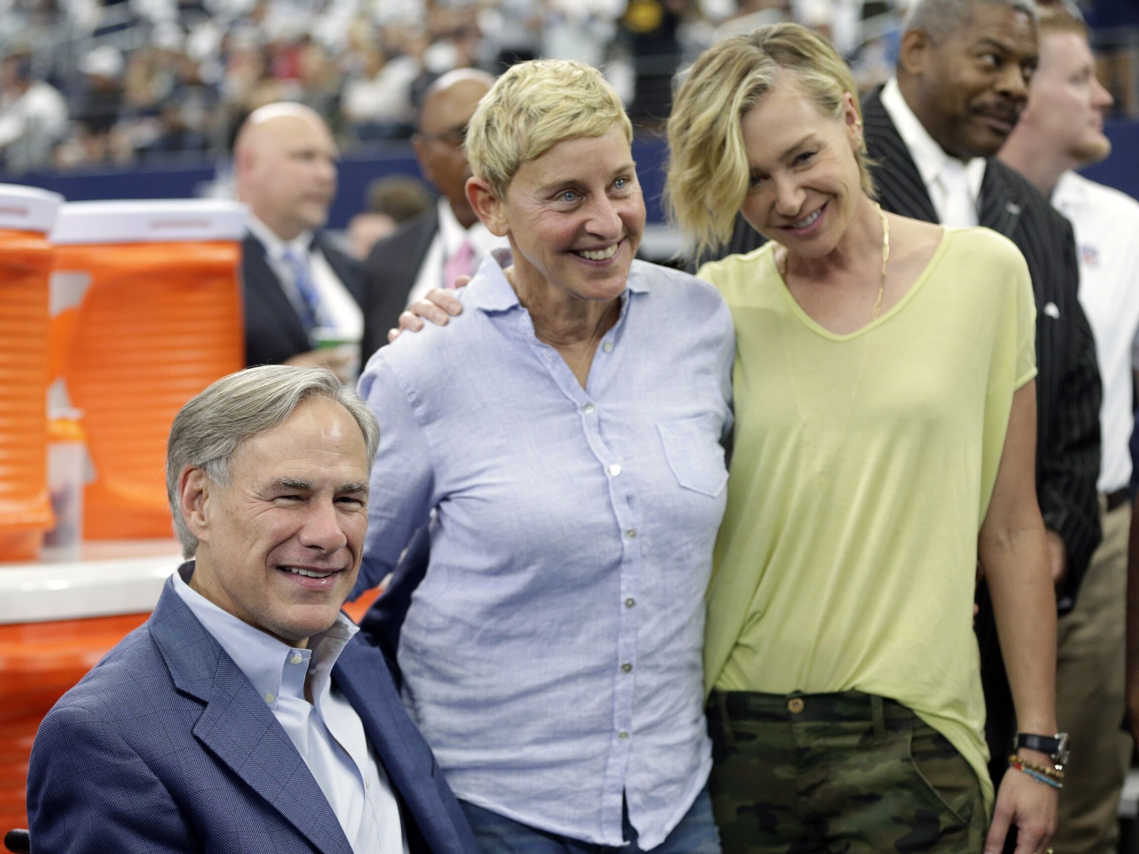 Oct 6, 2019; Arlington, TX; Texas governor Greg Abbott poses with talk show host Ellen DeGeneres and Portia de Rossi on the field before the game between the Green Bay Packers and the Dallas Cowboys at AT&amp;T Stadium.