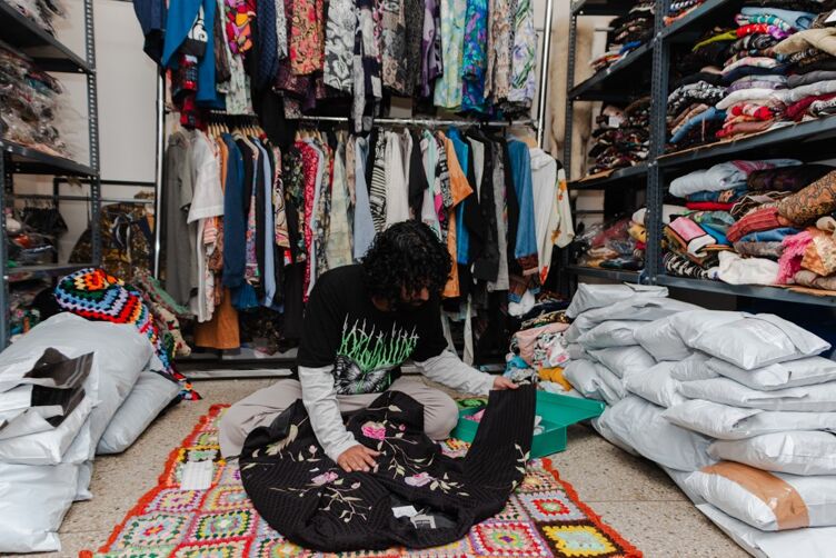 Dee inspects an upper as she packs it for shipment to Punjab at her warehouse in New Delhi, India.