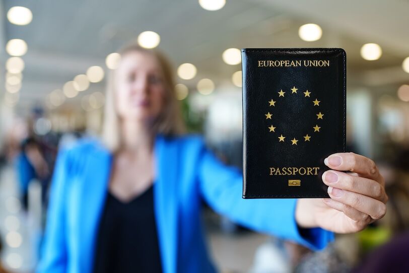 Woman showing passport of European Union.