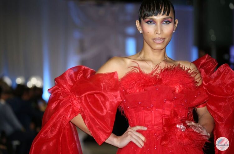 A model in a red dress strikes a pose at the TransLatin@ Coalition's GARRAS fashion show.