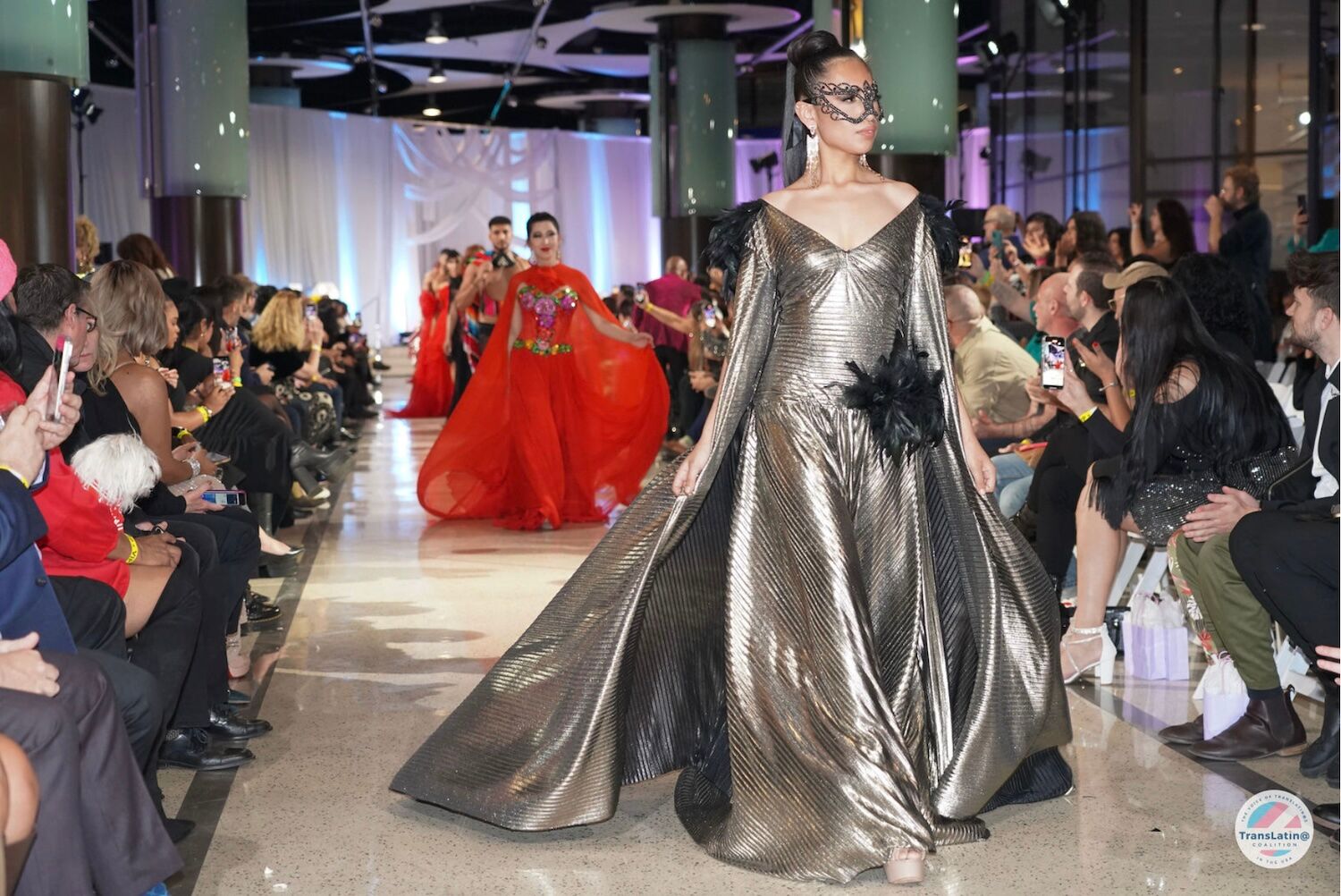 A model walks the runway in a silvery gown during the TransLatin@ Coalition's GARRAS fashion show.