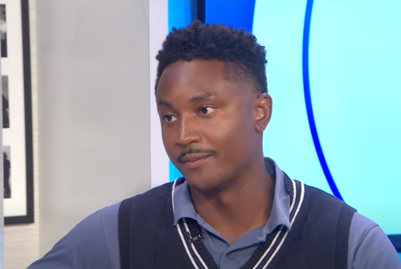 Chi Ossé is a young Black man in a blue collared shirt and sweater vest