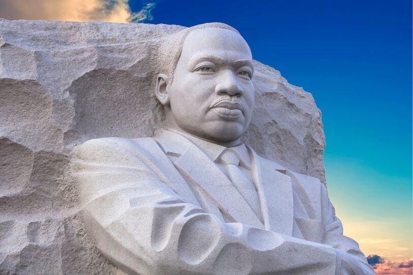 The memorial includes a large full body carving of MLK's likeness, in a suit and tie, his arms crossed and a serene just serious expression on his face.