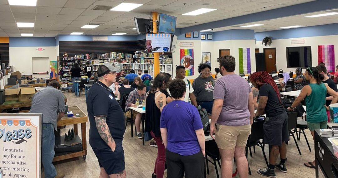 Players at Common Ground Games's tables participate in an LGBTQ+ Gayming Night.