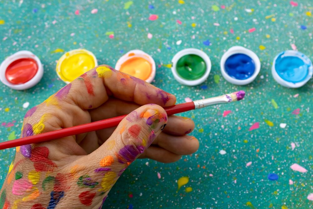 A paint-covered left hand.