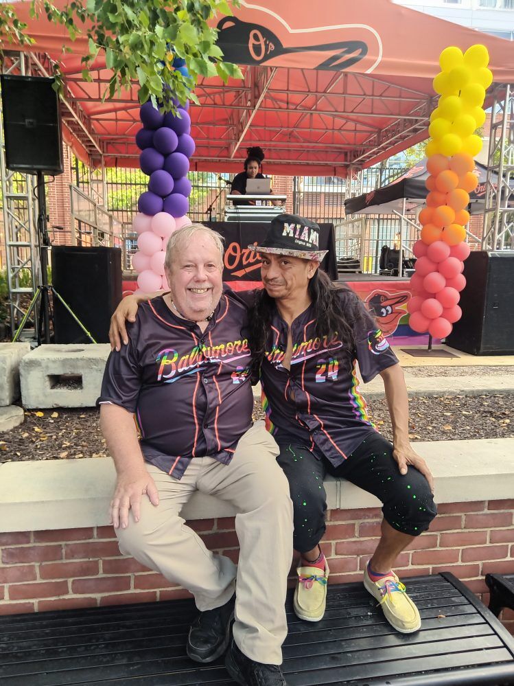 Eric Crossley and his partner Elcides Flores, pictured at Orioles Pride Night last year