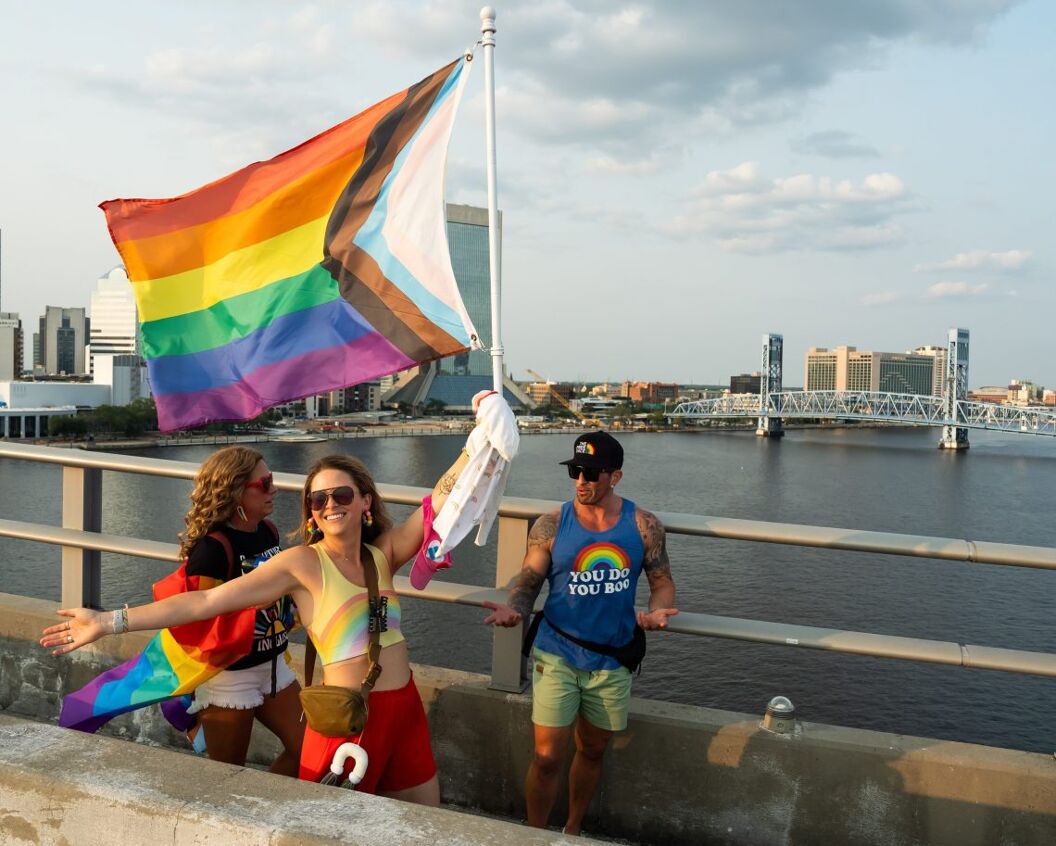 Mandy Rubin struts across the Acosta Bridge with a pride flag 