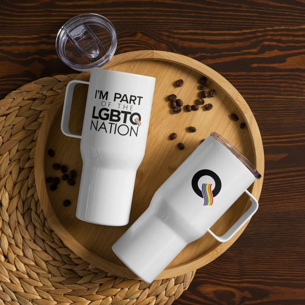 The front and back view of the “I’m Part of the LGBTQ Nation” Travel Mug with Handle with the rainbow Q on the opposite side.