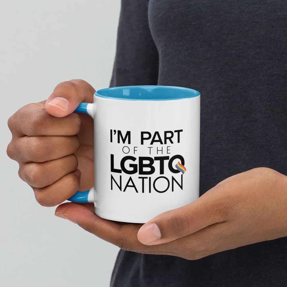 hands holding a light blue “I’m Part of the LGBTQ Nation” Mug with Color Handle