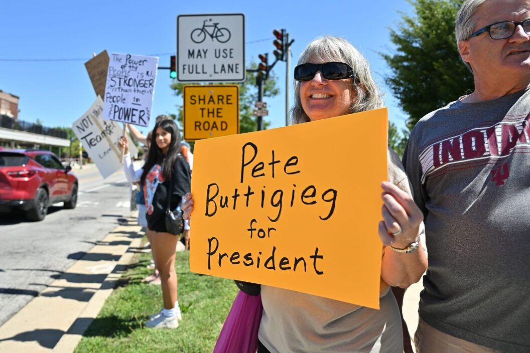 Karen Gaboury holds a sign supporting former South Bend Mayor and Secretary of Transportation Pete Buttigieg at a rally in support of the national day of action demonstrating against the Trump administration Monday, Sept. 1, 2025, at Howard Park in South Bend, Ind.