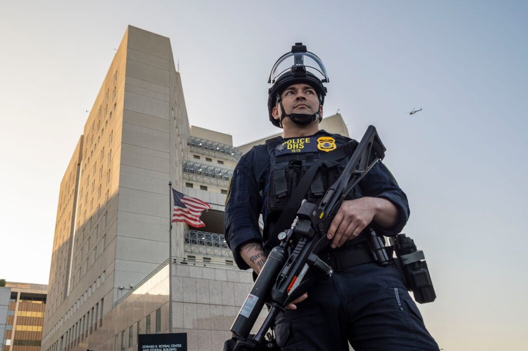 Law enforcement stand guard outside the Federal Building during a protest on Friday, June 13, 2025, in Los Angeles