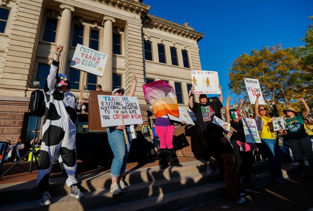 Protesters hold signs in support of transgender children during a No Kings Day protest on Saturday, October 18, 2025, at the Brown County Courthouse in Green Bay, Wis. The march and rally were part of a nationwide day of protest against the Donald Trump administration’s policies on a wide range of issues.